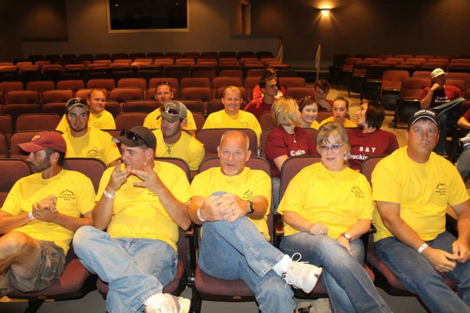 The group receiving instructions on how to ride a donkey prior to the game.