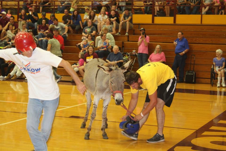 Person loses helmet while another person goes for the basketball