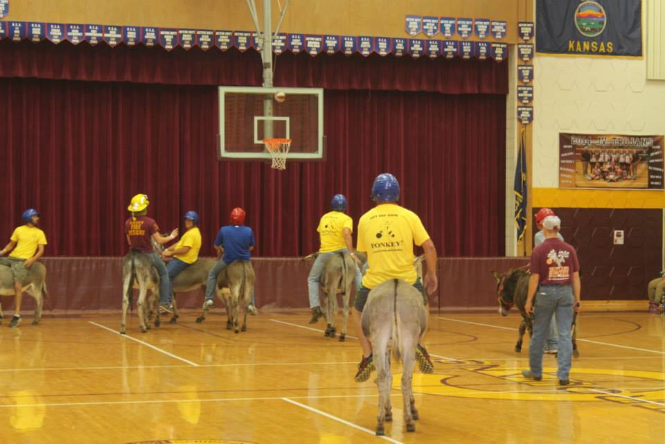 People on donkeys watch as the basketball soars to the goal
