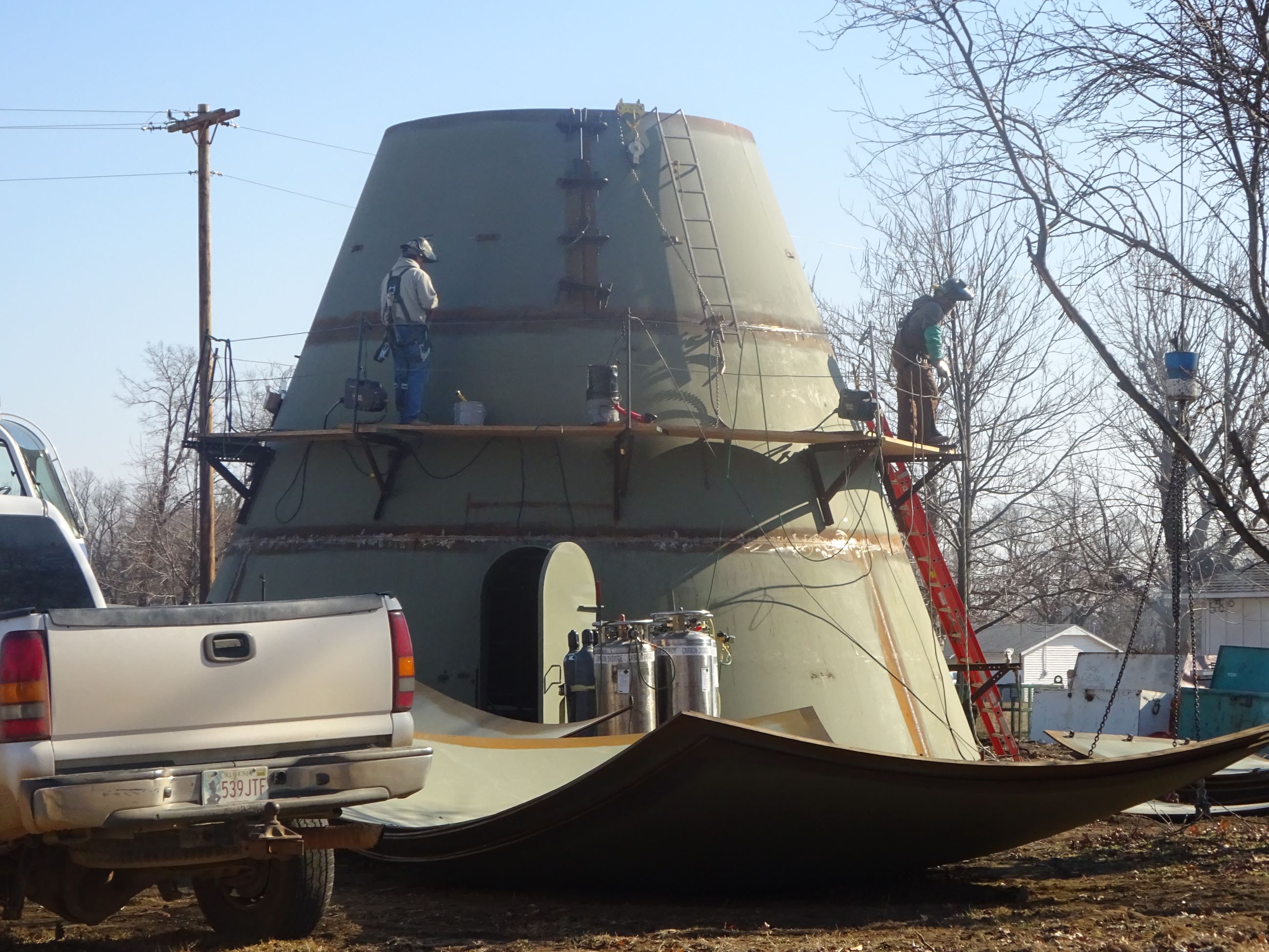 2 men on cat walk during construction of the East Water Tower