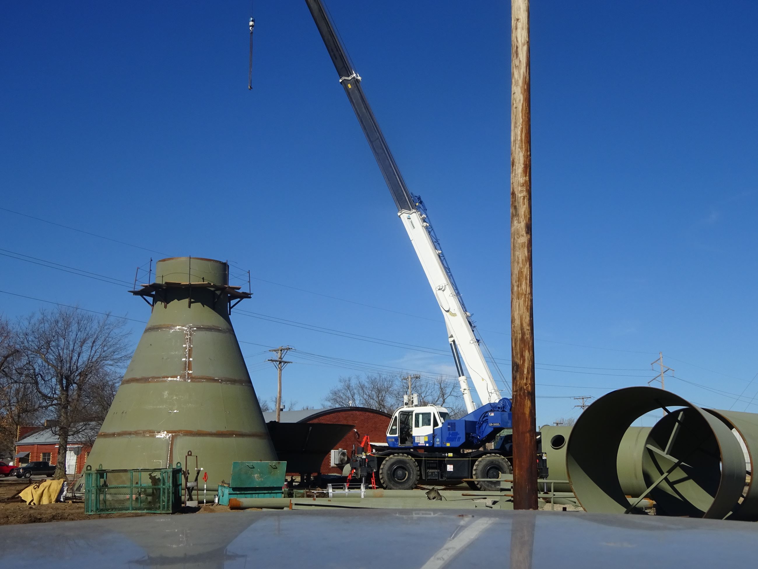 Crane hovering over part of East Water Tower