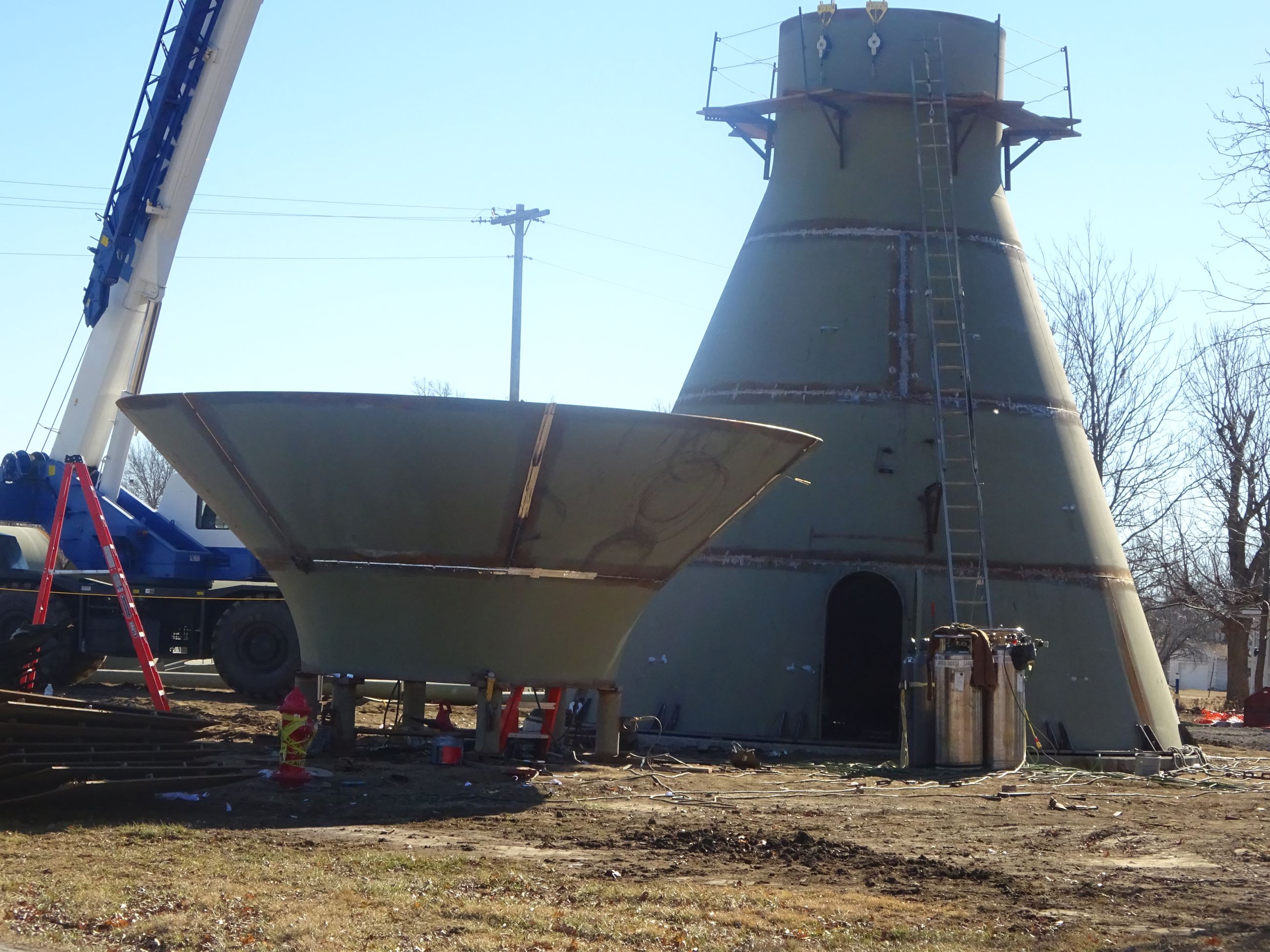 Crane lifting up part of the East Water Tower during construction