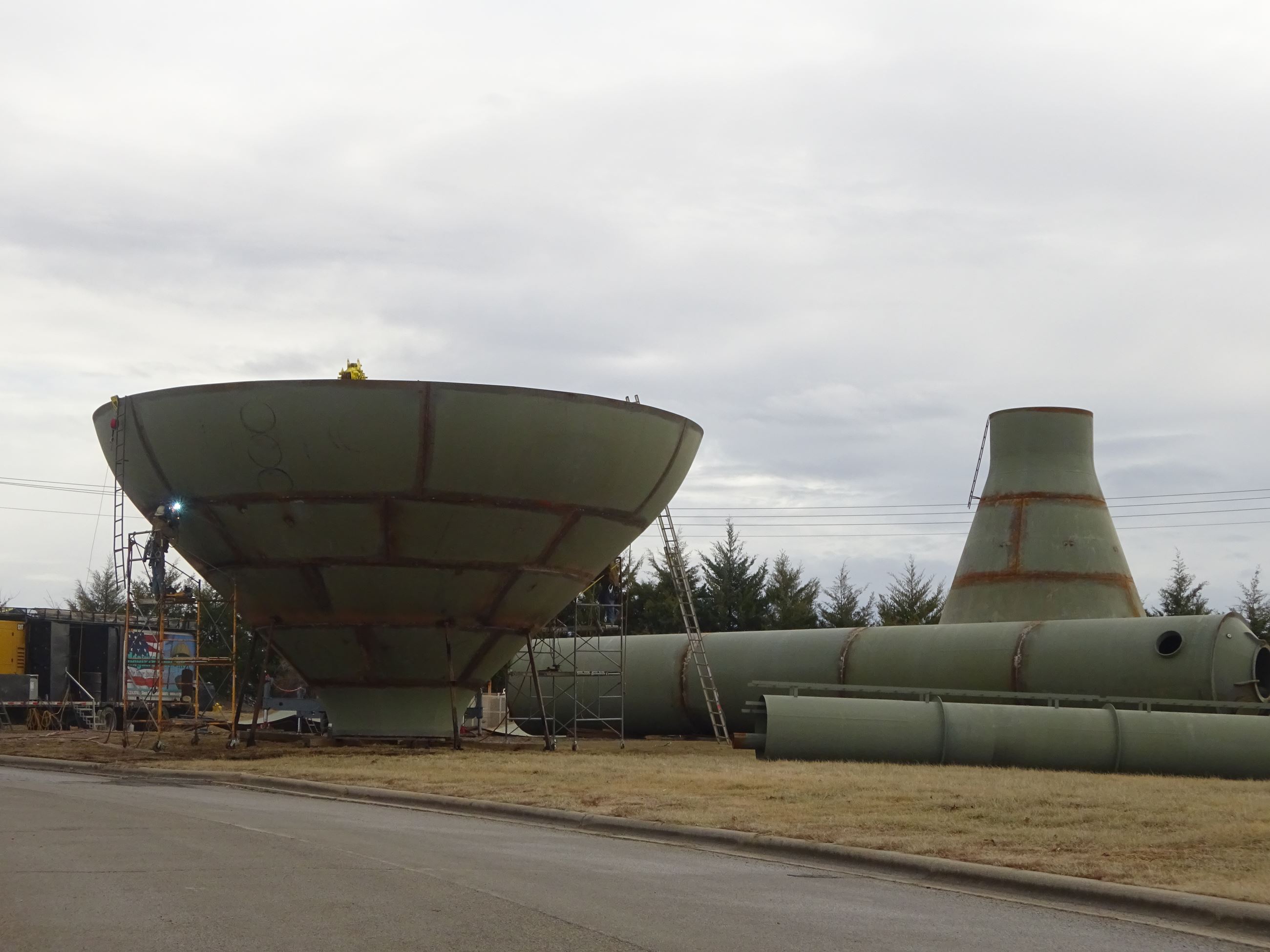Person welding on water tower